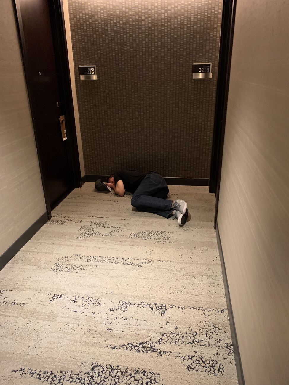 Jim asleep outside his hotel room, 2019