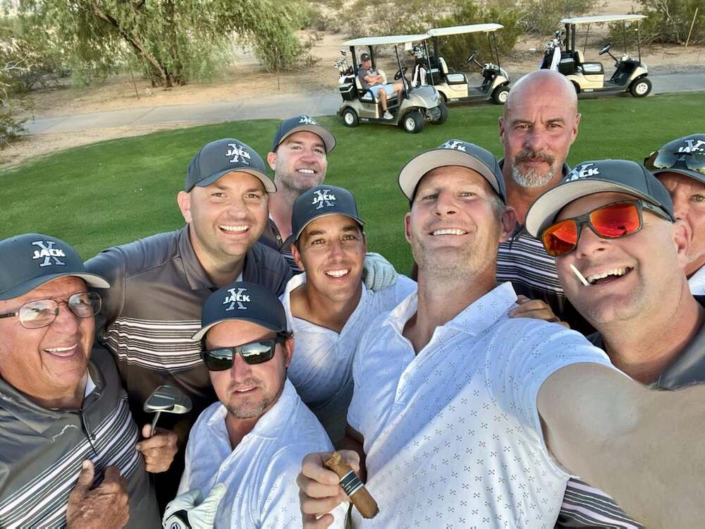The JACK X selfie — hats on, carts staged, cigars lit